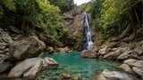 Tropical waterfall plunging into jade pool in jungle