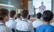 © Meow Creations - Medical students in lab coats and scrubs attending a lecture on human anatomy in a modern university hall