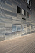 © yaqui_villegas - Linear metallic architecture with repetitive horizontal patterns and reflections, captured in sharp daylight for modern commercial use as structural background or texture