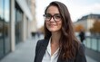 © fu - Young woman with glasses in urban environment, Germany cityscape background, professional attire, multicultural lifestyle, diversity and inclusion theme. High quality