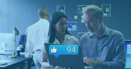 Poster - Reviewing laptop notification, woman and man collaborating in office, with desk lamp coffee charts
