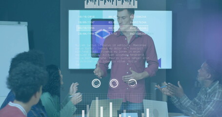 Poster - Presenting speaker in red button-up talking at meeting table, with display screen and whiteboard