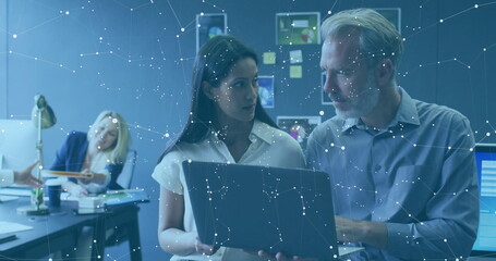 Poster - Reviewing professionals in office attire examining laptop screen at corporate office, with monitors