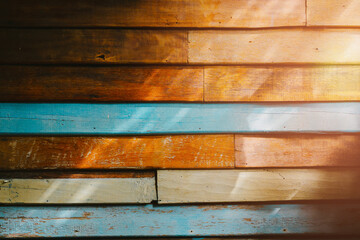 Poster - Wood background. Colorful and Textured Wooden Wall Panels Showcasing Natural Patterns and Shadows in Warm Sunlight