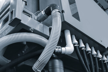 Poster - Large machine with many white pipes and wires industrial background for a web banner template page blue tone