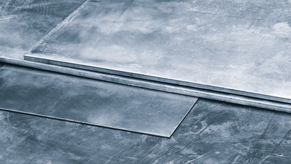Aufkleber - metal sheet is being cut by a machine. machine is surrounded by a metal frame industrial concept blue background
