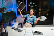 © Kritdanai - Happy Asian Woman Celebrating Coding Success at Night