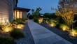 © Karen - modern gardening landscaping design details illuminated pathway in front of residential house landscape garden with ambient lighting system installation highlighting flowers plants