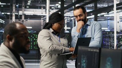 Aufkleber - Data center engineers performing maintenance on blade server units used for artificial intelligence processing. IT professionals manage data center arrays used for machine learning training, camera A