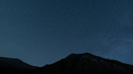 Wall Mural - Beautiful night sky time lapse with Milky Way galaxy over mountain. Night tight landscape starry sky.