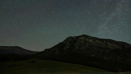 Wall Mural - Beautiful night sky time lapse with Milky Way galaxy over mountain. Night tight landscape starry sky.