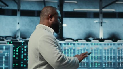 Poster - Technician working in high tech server hub, analyzing data on tablet to ensure seamless data flow. IT expert examining equipment in data center, ensuring system integrity and security, camera B