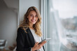 © mattegg - Smart woman smiles holding tablet in a modern office a successful woma