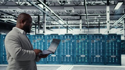 Poster - Data center engineer deploying AI driven management tools using laptop. Server farm employee inspecting server clusters, updating network topologies using artificial intelligence, camera A