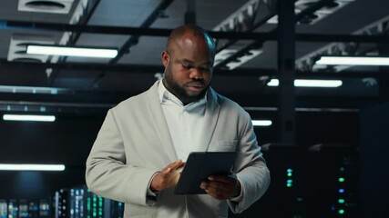 Poster - System administrator walking in data center analyzing infrastructure performance outputs on tablet. Server farm employee doing job tasks, finetuning supercomputers configurations, camera B