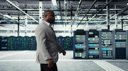 Poster - System administrator walking in data center with rigs handling queries, doing backups. Admin overseeing server farm with gear hosting digital services, powering client platforms, camera A