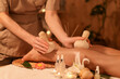 © Pixel-Shot - Beautiful young woman receiving feet massage with herbal bags in dark spa salon, closeup