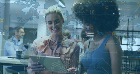 Poster - Standing professional women side by side examining tablet in tech office, with digital map overlay