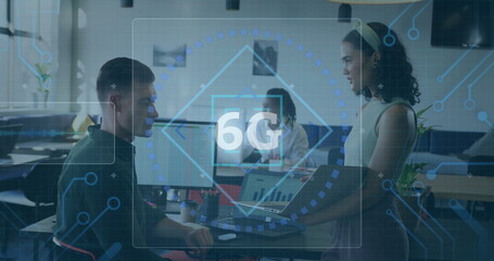 Poster - Three professionals analyzing digital 6G overlay in office, holding laptop and pointing at monitor