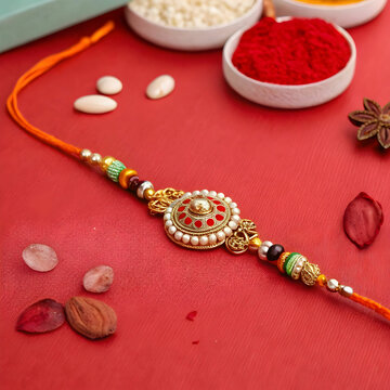 A vibrant Raksha Bandhan greeting with a red background and decorative rakhi, symbolizing the bond of love and protection between siblings.
