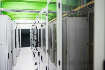 Poster - Server rack cabinets are lining aisle in flat design, featuring green beams and white floor tiles