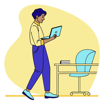 Man with laptop walking past desk and chair in modern office