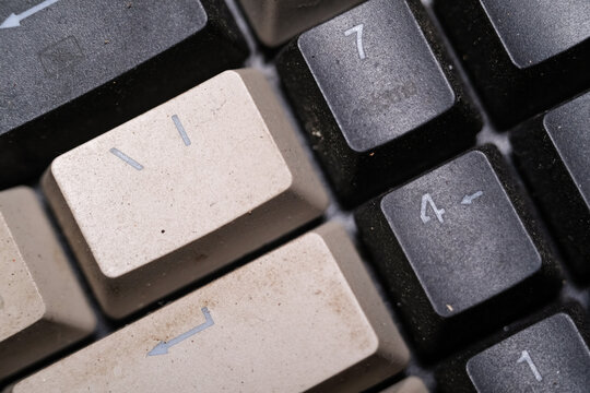 Close-up shot of square key caps in gray and black. Macro Photography of mechanical keyboard with two unique and cool colors. Dirty keycaps with dirt and crust closeup. Technology Backgrounds