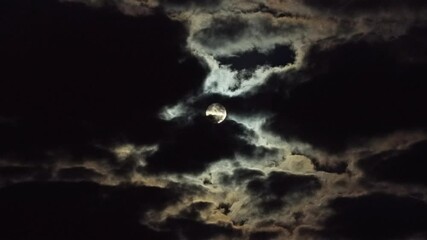 Wall Mural - telephoto drone shot of a full moon cloudscape, illuminating the night sky