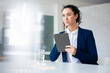 © Westend61 - Thoughtful businesswoman holding digitized pen and tablet PC