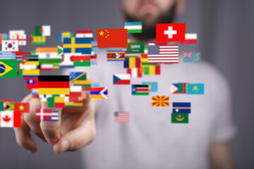 Poster - Diverse flags float around a person's hand, symbolizing global reach and connection.