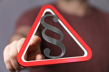 Poster - Hand pointing at a digital red triangle warning sign with a paragraph symbol.  Legal concept.