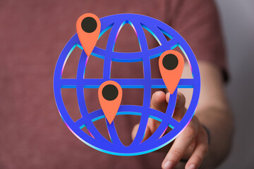 Poster - A person interacts with a 3D globe displaying multiple location markers, representing global connectivity.