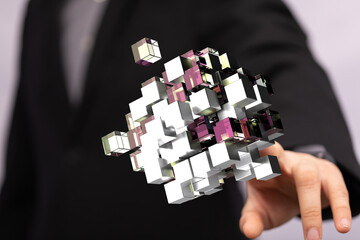 Poster - Abstract image of a businessman holding interconnected cubes, symbolizing network, data, or technology.