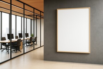 Poster - Modern office interior with large blank vertical poster frame on dark wall beside glass-walled meeting room with computers and minimalist decor.