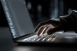 © AI PHOTO STUDIO - Dark workspace with a person typing on a laptop during late night hours