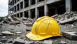 © Yurii - A damaged yellow safety helmet lies on the rubble next to a collapsed concrete building, bringing to mind an industrial collapse and potentially dangerous site conditions.
