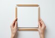 © Vooglo.com - Hands holding blank white paper sheet framed with pencils isolated on white background