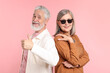 © New Africa - Senior couple in stylish outfits on pink background