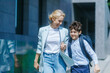 © Alexandr - happy Mother and schoolboy walking hand in hand to school on a sunny morning