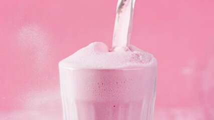 Poster - A glass container filled with pink powder sits on a table, possibly used for cosmetics or art projects