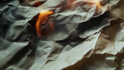 Poster - A close-up shot of a piece of paper being consumed by flames