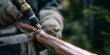 © Amazight - A worker welds a copper pipe, using a professional torch, sparking brightly