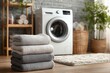 © ProStockPhoto - Freshly laundered towels of various shades are neatly stacked near a washing machine in a warm and inviting laundry space