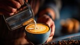 Barista pouring milk into latte