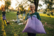 © Zamrznuti tonovi - Senior woman volunteer holding trash bag cleaning park