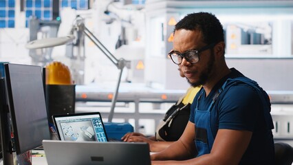 Poster - black engineer inputs solar system parameters at industrial workstation, using pc in a renewable ene