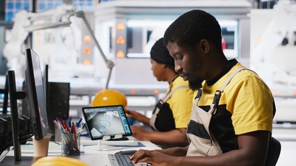 Poster - african american technician evaluates renewable energy metrics at pc station, using advanced monitor
