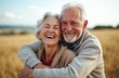 © miss irine - Happy elderly couple hug and smile in nature. Affectionate man and woman enjoy retirement, vacation at countryside. Romantic moment of senior couple, joy, relaxation, family love.