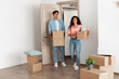 © Prostock-studio - Unhappy confused millennial couple homeowners holding cardboard boxes walking in new house, young family of two people moving into bad flat, sad guy and lady disappointed in interior design