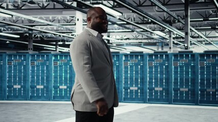 Poster - Happy businessman walking in data center, assessing rackmounts capacity before investing. Jolly management executive overseeing server farm built for business storage gear, camera A